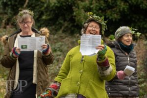 Singers in the orchard with ivy crowns